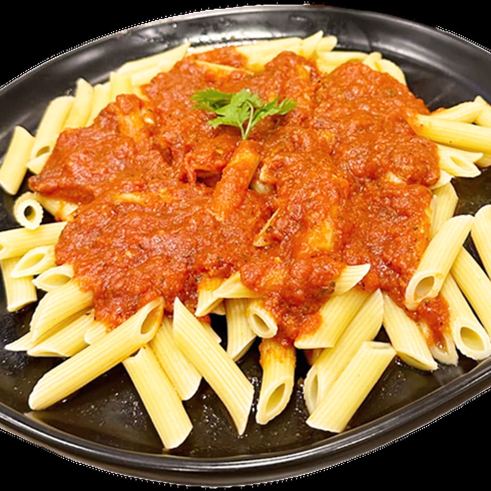 Penne pasta with a rich red tomato sauce and a sprig of parsley on a black plate.