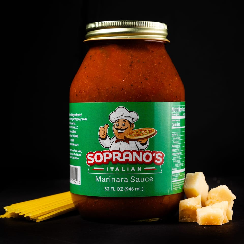 Soprano's Italian Marinara Sauce jar with spaghetti and parmesan cheese on a black background.